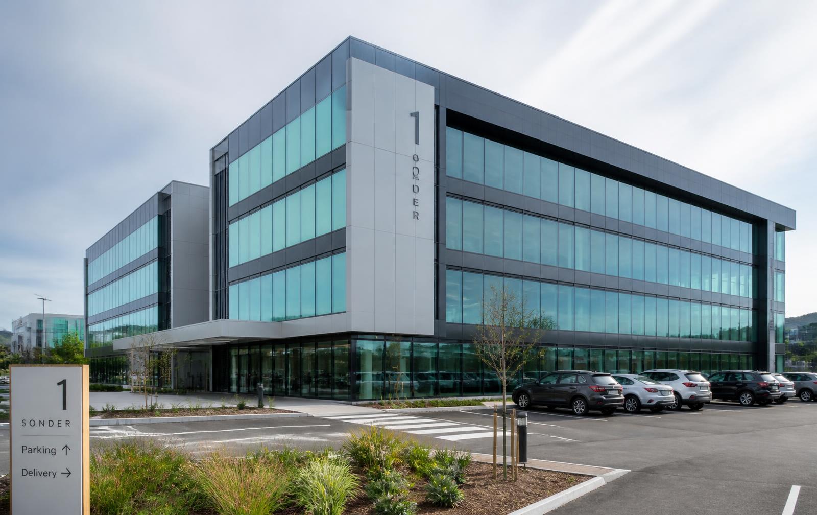 Modern commercial office building with maintained grounds and car park in Wellington